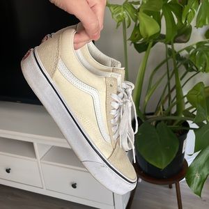 Cream two toned vans.